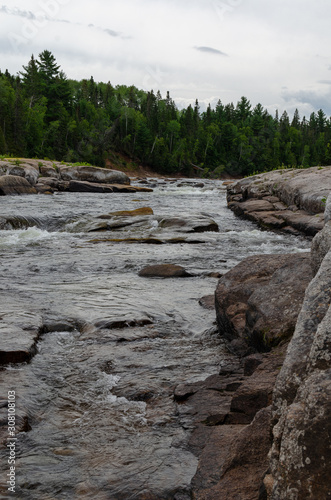 Rapid moving water at Pabineau Falls, New Brunswick, Canada photo