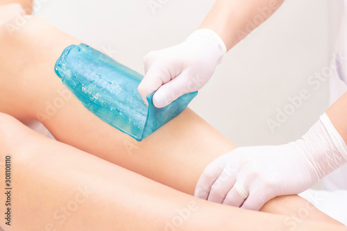 azulene depilation. wax hair removal, shugaring. concept of smooth skin without hair. azulene of green color. removal of azulene from the skin