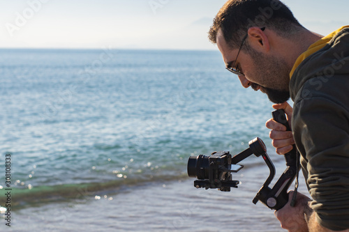 videographer using mirrorless camera tool for stabilizer anti-shake record video scene