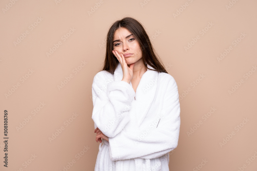 Young girl in a bathrobe over isolated background unhappy and frustrated Young girl in a bathrobe over isolated background unhappy and frustrated