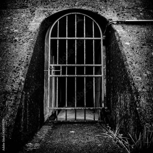Spooky gated entrance way into stone wall