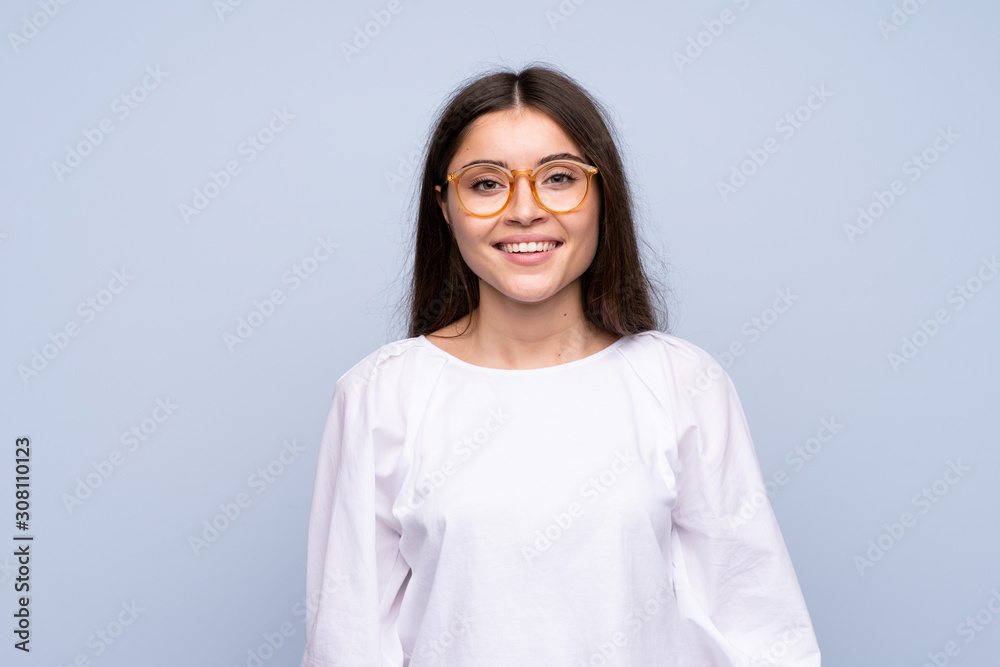 Young woman over isolated blue background with glasses Young woman over isolated blue background with glasses