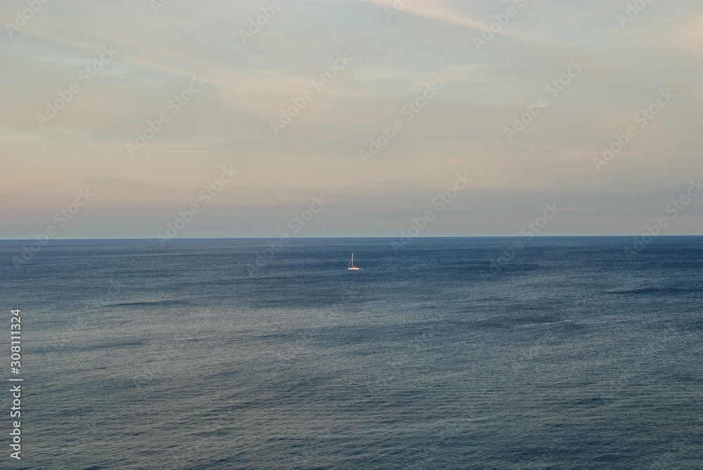 Barcelona, Spain - 18.08.2019: Beautiful white sailing yacht in the blue huge sea