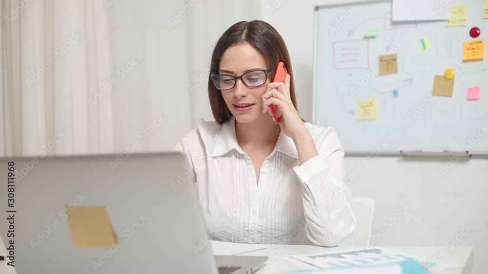 Business friendly woman talking on the phone. A woman advises a client on a smartphone. Business friendly woman talking on the phone. A woman advises a client on a smartphone.
