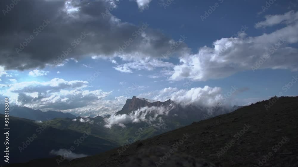 White clouds against the background of the time lapse mountains. Northern Caucasia. Russia White clouds against the background of the time lapse mountains. Northern Caucasia. Russia