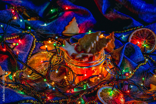 Festive decoration with lights and the cookies on blue. photo