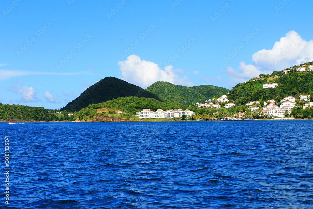 Looking from a boat at the houses and buildings on the shore and hills, St. Lucia, West Indies