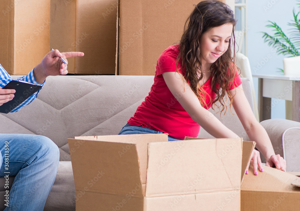 Young pair moving in to new house with boxes Young pair moving in to new house with boxes
