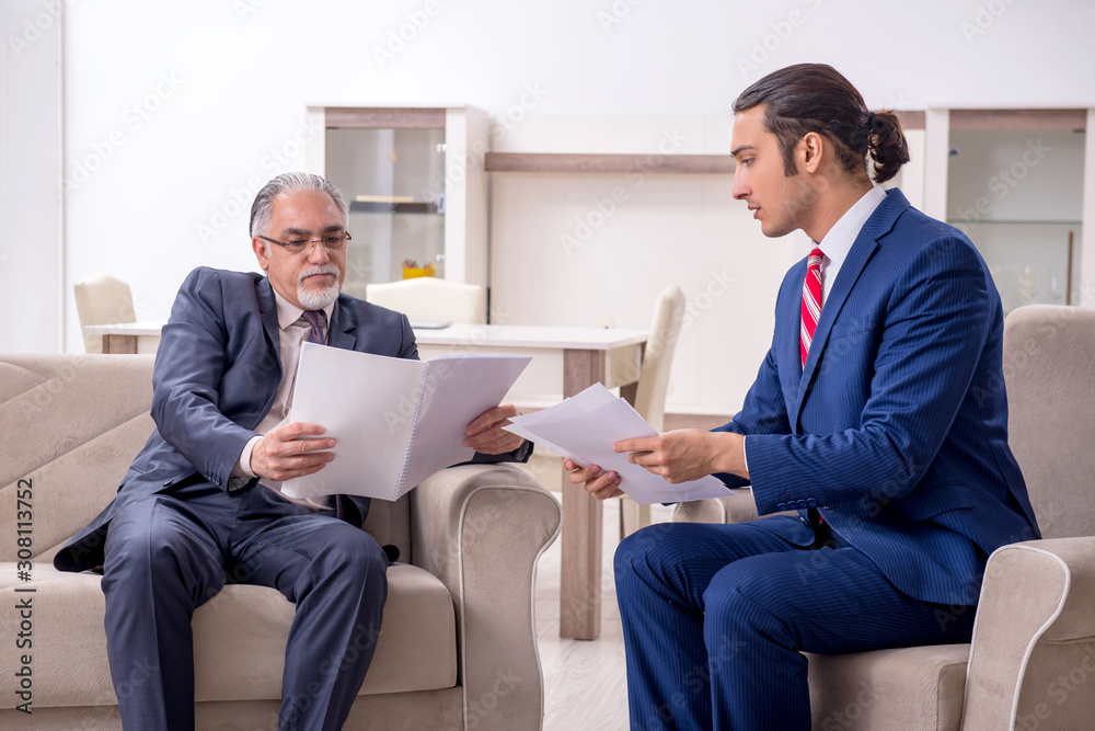 Two businessman discussing business in office Two businessman discussing business in office