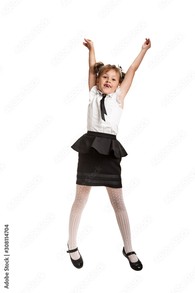 Happy cheerful girl in school uniform jumping on white background Happy cheerful girl in school uniform jumping on white background