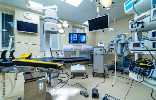 establishing shot of technologically advanced operating room ready for surgery. real modern operating theater with working equipment, lights and computers.