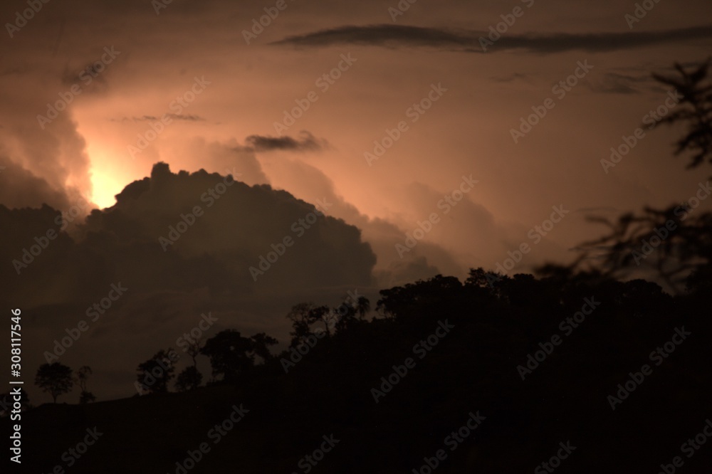 Fototapeta premium Lightning hiding in the clouds.