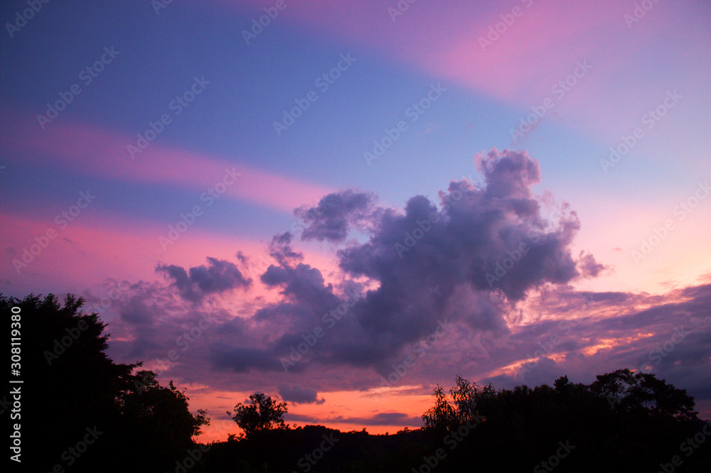 Pink anti-crepuscular rays with clouds during sunset.