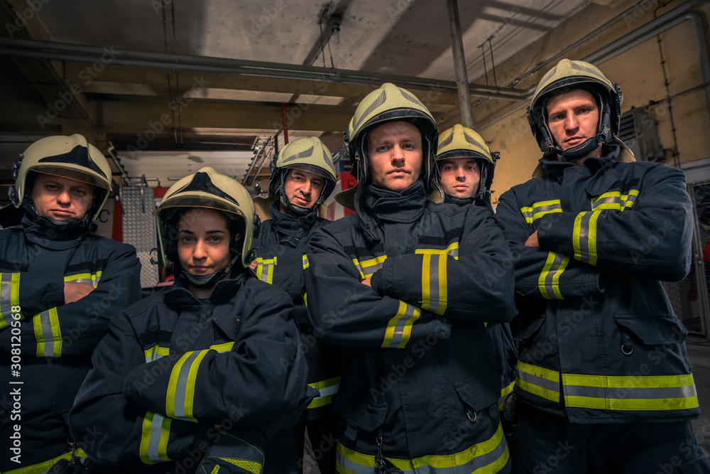 Group of firefighters standing confident with arms crossed. Firemen ready for emergency service. Group of firefighters standing confident with arms crossed. Firemen ready for emergency service.