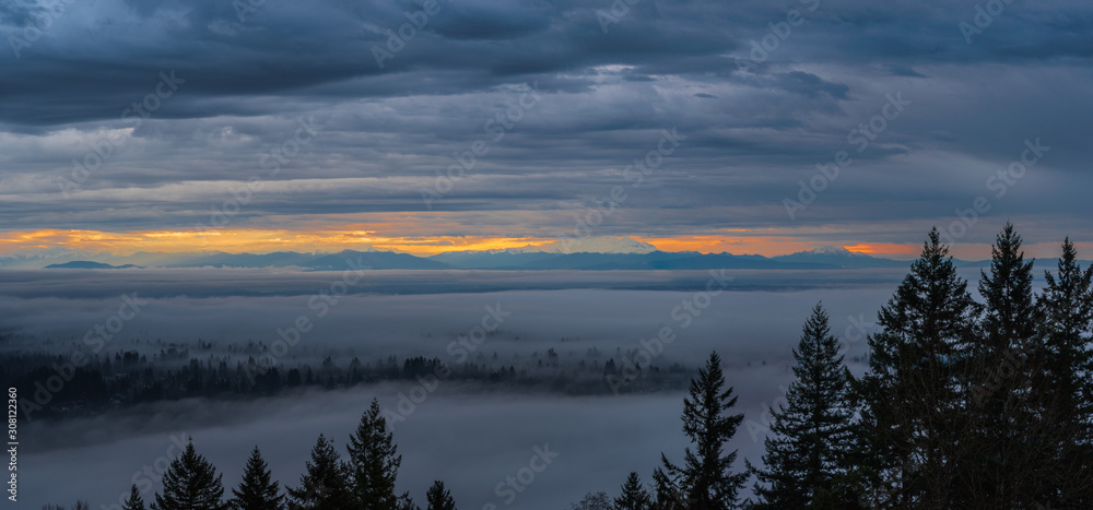 Sunrise over distant Mount Baker reveals cloud inversioon on valley floor