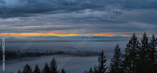 Sunrise over distant Mount Baker reveals cloud inversioon on valley floor