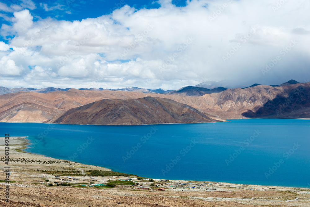 Obraz premium Ladakh, India - Aug 08 2019 - Pangong Lake view from Spangmik Village in Ladakh, Jammu and Kashmir, India. The Lake is an endorheic lake in the Himalayas situated at a height of about 4350m.