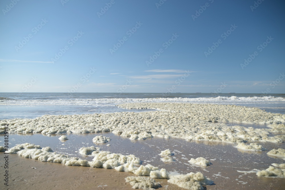 Sea foam on the beach in large quantity - wide angle - in Den Haag  , Holland