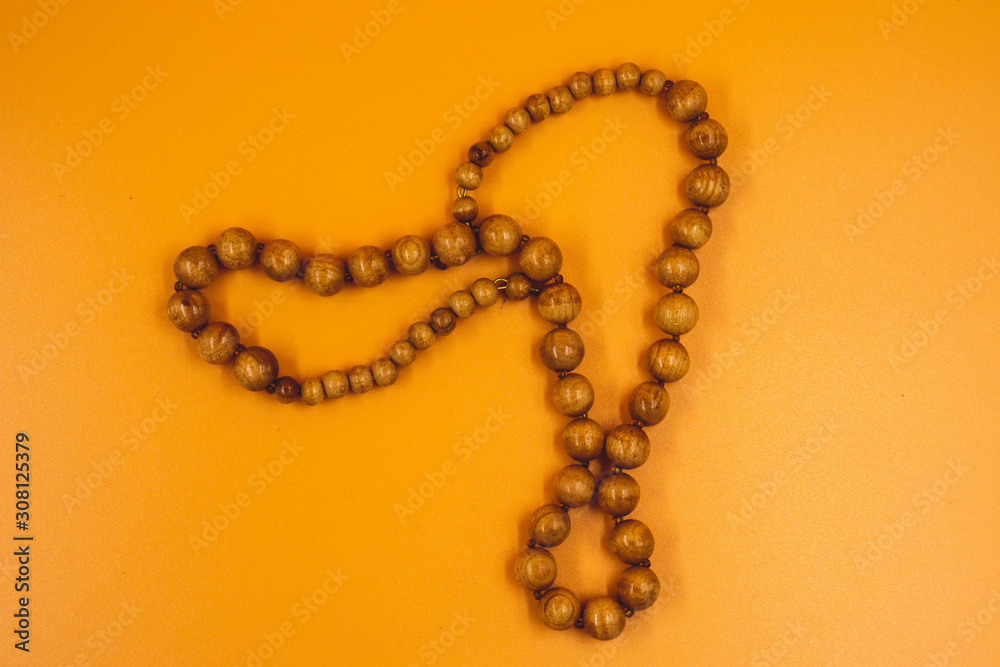 rosary beads isolated on orange background rosary beads isolated on orange background