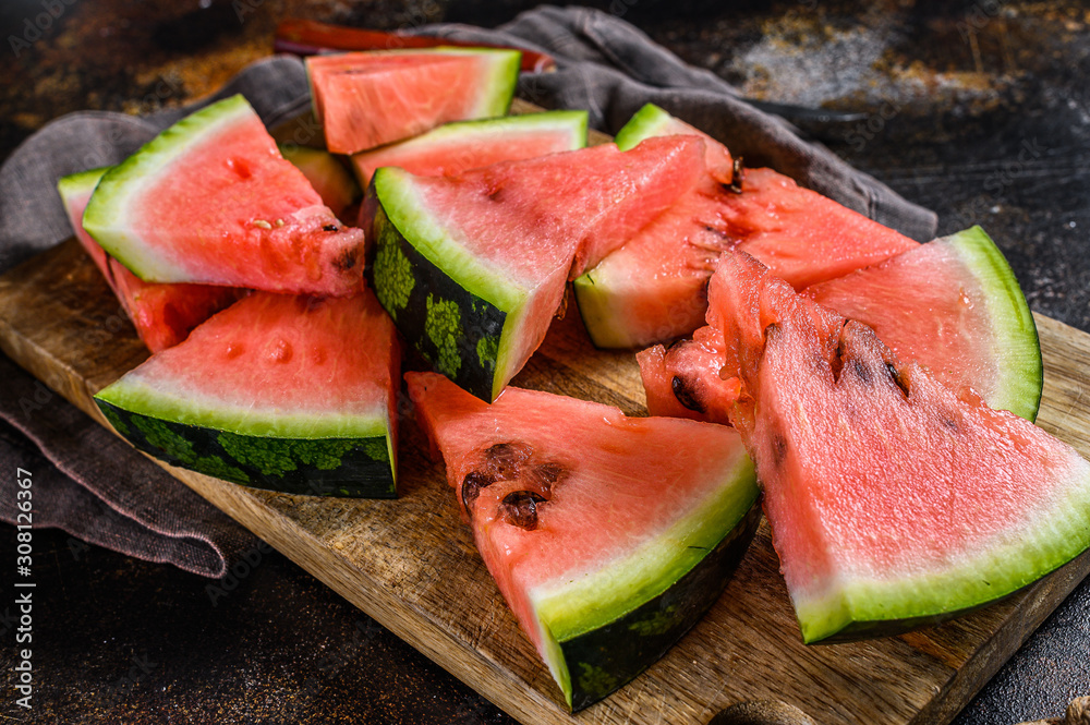Slices of ripe watermelon on a wooden cutting Board. Selective focus