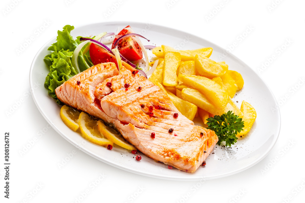 Roast salmon, french fries and vegetables on white background Roast salmon, french fries and vegetables on white background