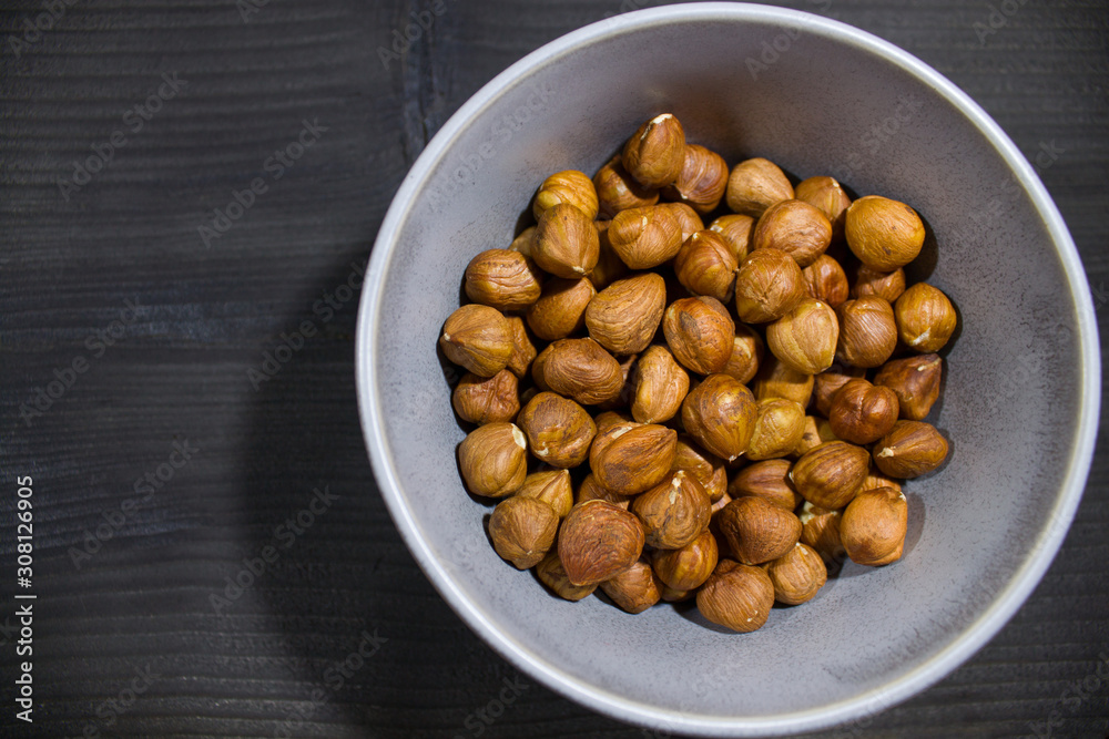 plate with nuts on a gray background with scattered hearts plate with nuts on a gray background with scattered hearts