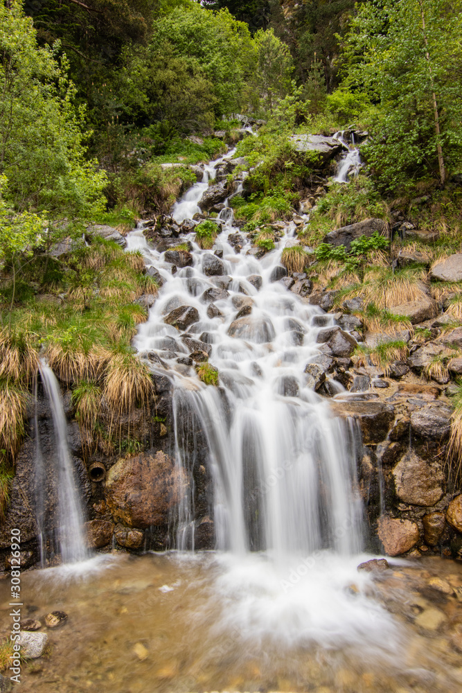 A small cascade waterfall, near a village of Encamp, Andorra. Located in the Pyrenees mountain