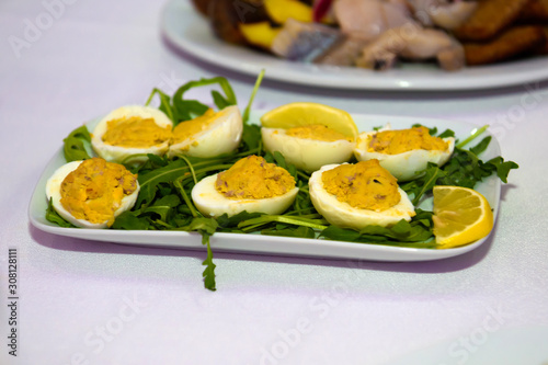Eggs stuffed on the table. Snacks and utensils for a dinner party.