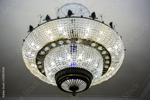 Luxurious Palace large chandelier. Light In the interior of a Grand room.