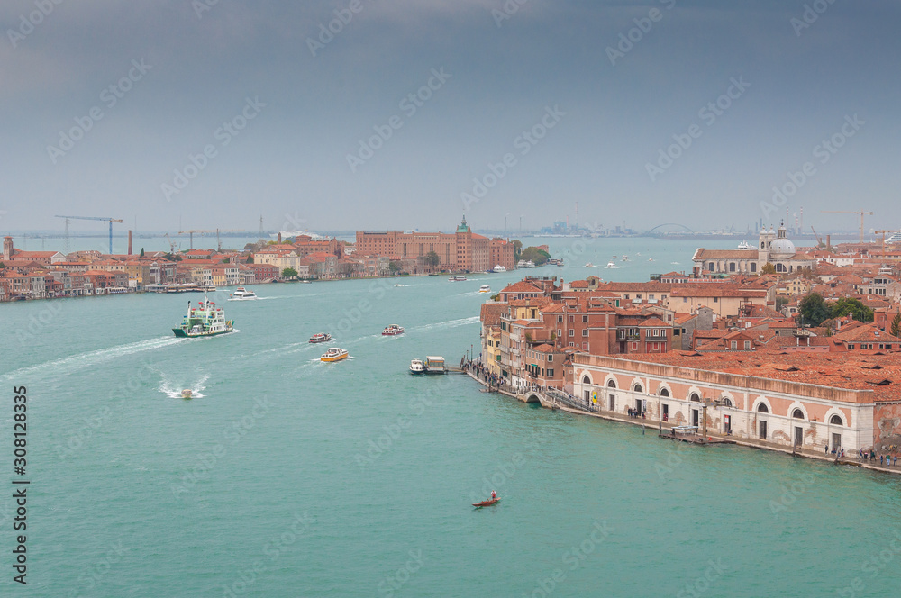 Aerial view of Giudecca Channel with boat traffic, Venice, Italy. Concept: historic Italian places, evocative and little-known views of Venice, boat traffic in Venice Aerial view of Giudecca Channel with boat traffic, Venice, Italy. Concept: historic Italian places, evocative and little-known views of Venice, boat traffic in Venice