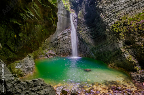Hidden waterfall in the mountain canyon
