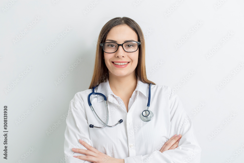 Portrait of a friendly young female professional doctor in a white medical coat. Portrait of a friendly young female professional doctor in a white medical coat.