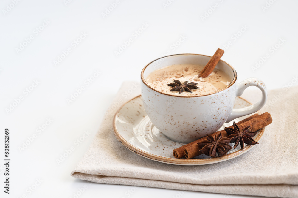 Indian Masala chai tea. Traditional Indian hot drink with milk and spices on white background closeup. Indian Masala chai tea. Traditional Indian hot drink with milk and spices on white background closeup.