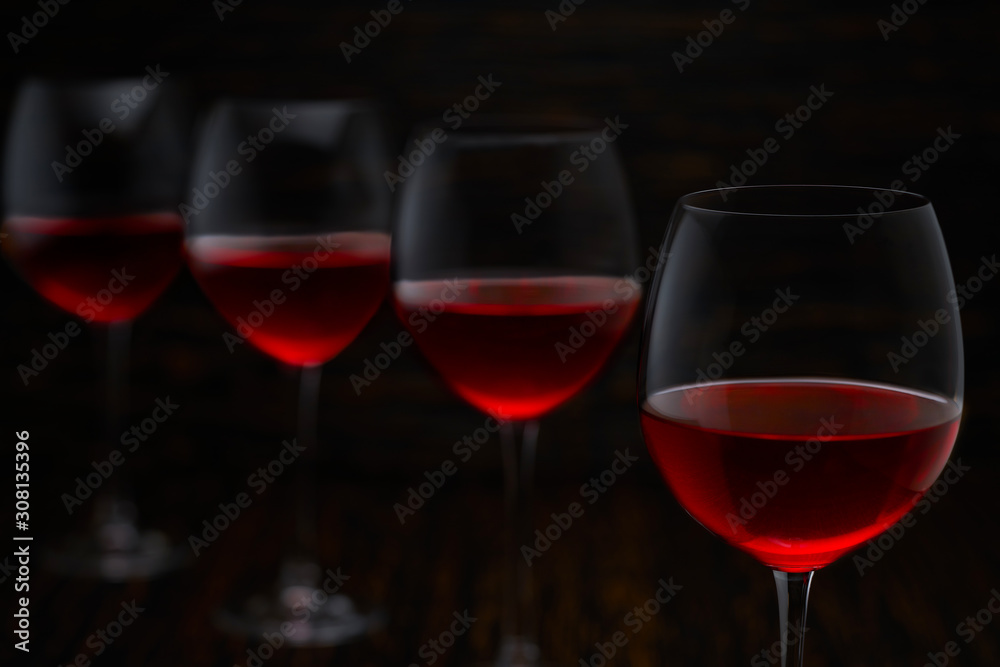 Red wine on a black wooden background, close up.