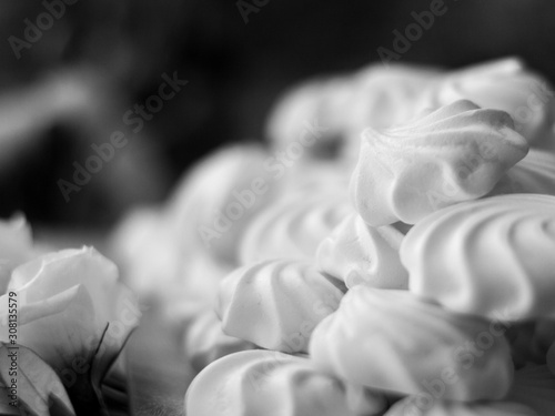 A pile of white and sweet marshmallows in black and white