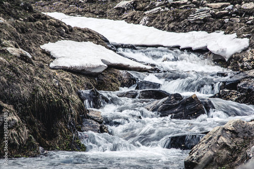 Landscape view of a river and remaining of ice and snow.Springtime in Sharr Mountains, North Macedonia. photo