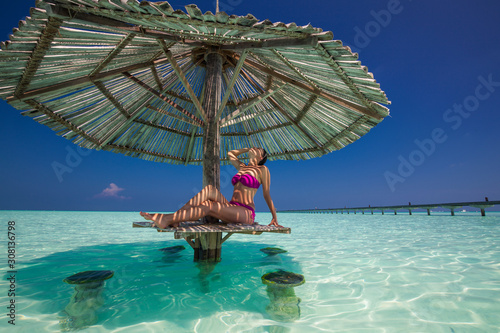 Young gorgeous woman in bikini on a tropical island photo