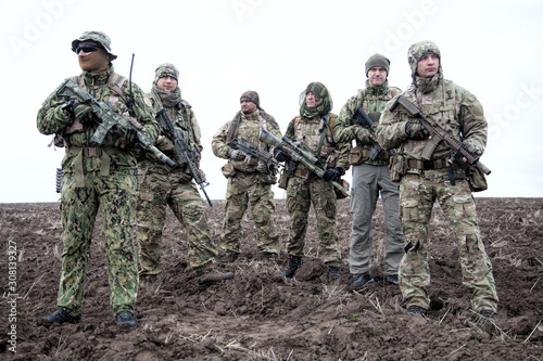 Army soldiers group on march in muddy field aaa aaaa aaaa aaa photo