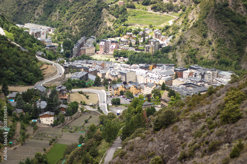 A view of Andorra La Vella from a hike high in the mountains around pine trees.
