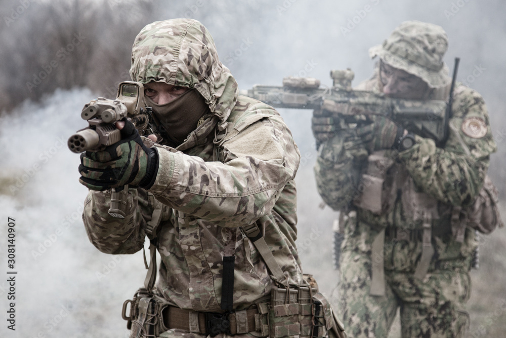Fototapeta premium military soldiers attacking enemies trough smoke screen