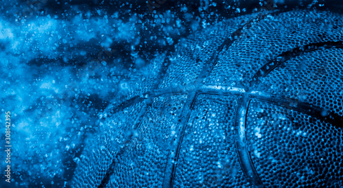 Closeup detail of basketball ball texture background. Blue filter © Augustas Cetkauskas