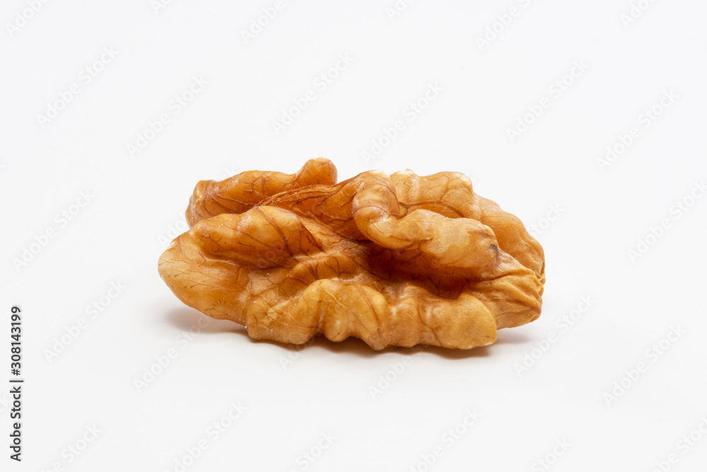 One peeled walnut on a white background. One peeled walnut on a white background.