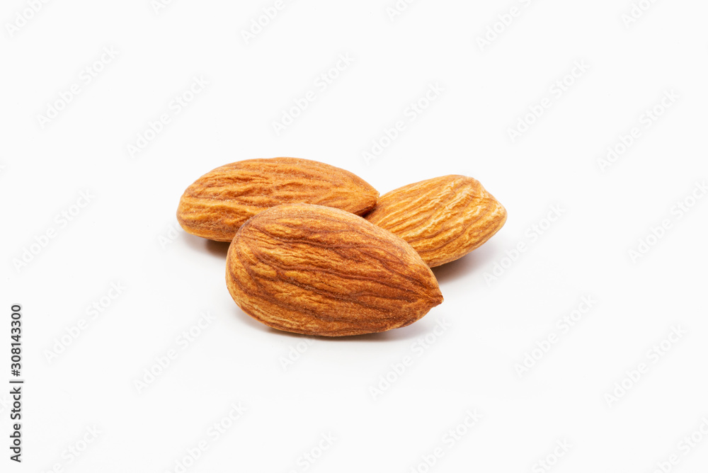 Close up shot of three roasted almonds on a white background. Close up shot of three roasted almonds on a white background.