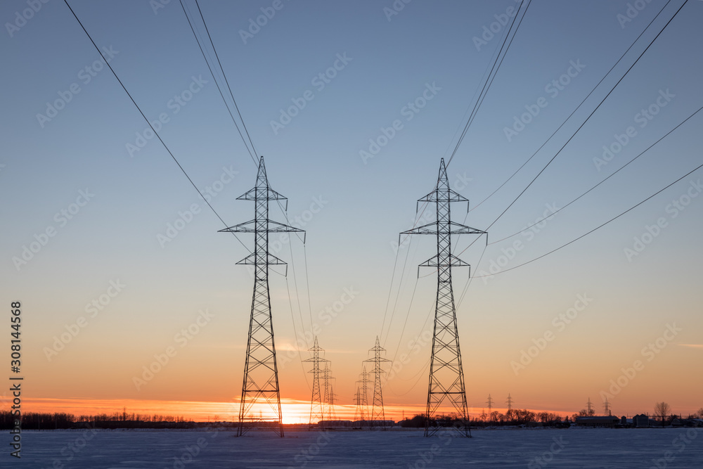 Two Power Transmission Towers Against a Prairie Sunset