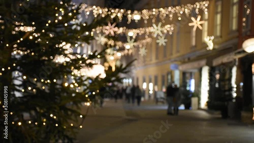 Abstract blurred street view with beautiful Christmas decorations, at night, in the city center of Graz, Styria region, Austria.