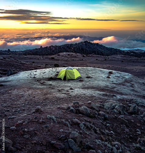 Chimborazo volcano and a tent camping in a beautiful sunset, Andes, Ecuador