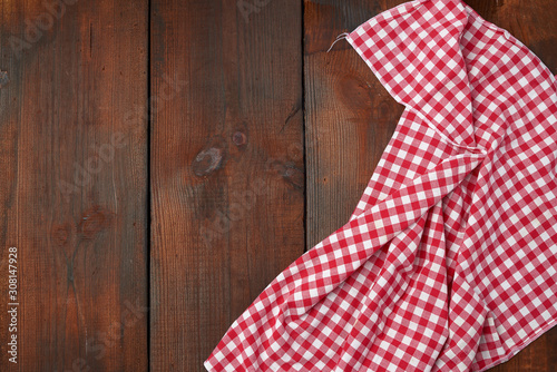 white red checkered kitchen towel on a brown wooden background