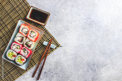 japanese sushi food. Rolls with tuna, salmon, shrimp, crab and vegetables. Top view of assorted sushi. Rainbow sushi roll on stone background. Flat lay