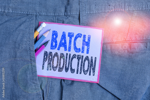 Text sign showing Batch Production. Business photo text products are analysisufactured in groups called batches Writing equipment and purple note paper inside pocket of man work trousers photo