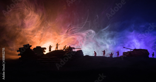 War Concept. Military silhouettes fighting scene on war fog sky background  World War German Tanks Silhouettes Below Cloudy Skyline At night. Attack scene. Armored vehicles and infantry.